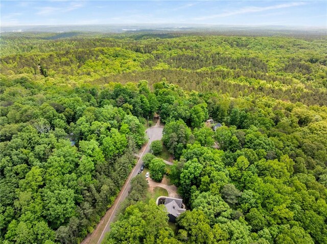 drone / aerial view with a wooded view