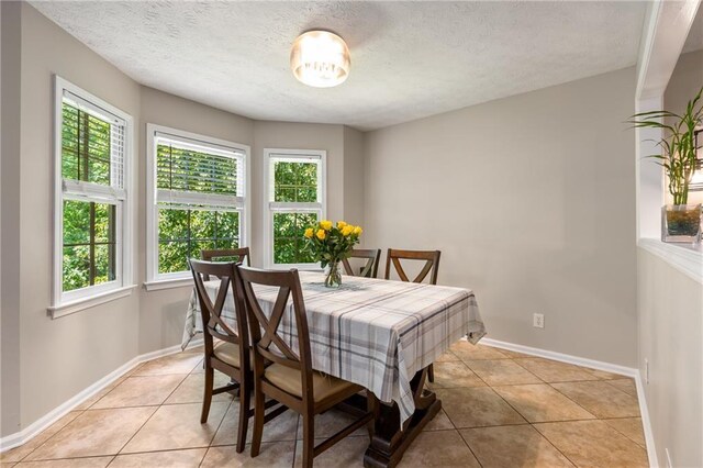 dining room with a healthy amount of sunlight and light tile patterned floors