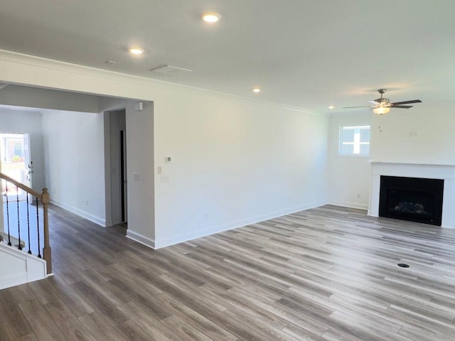 62 Sheryl Way, Loganville, GA 30052 - unfurnished living room with a ceiling fan, ornamental molding, wood finished floors, baseboards, and a fireplace