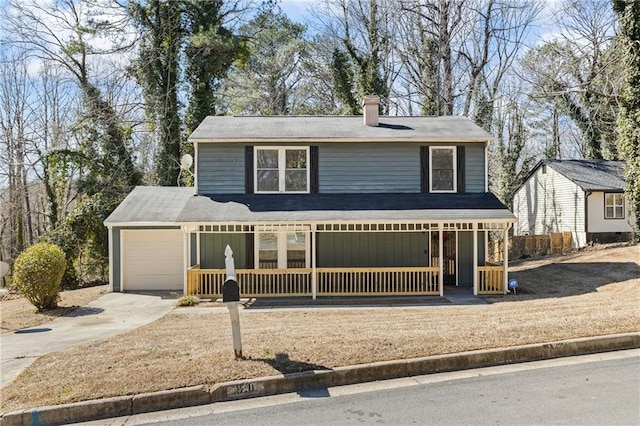 traditional-style house with driveway, a porch, a chimney, and an attached garage