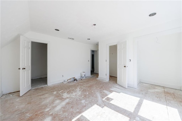 spare room with vaulted ceiling