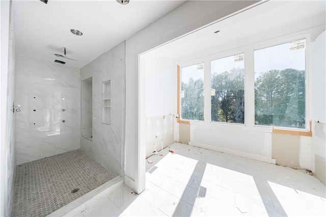 bathroom with a tile shower