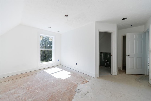 unfurnished bedroom featuring lofted ceiling