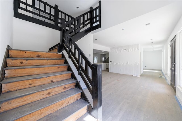 stairway with hardwood / wood-style flooring