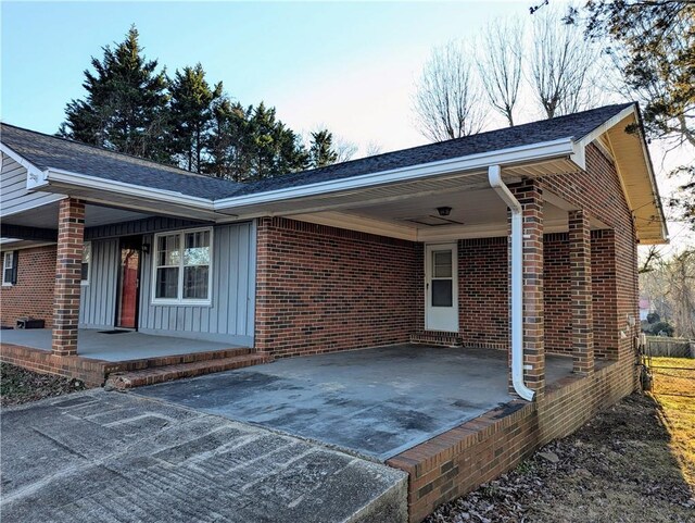 rear view of house with a yard, fence, and brick siding