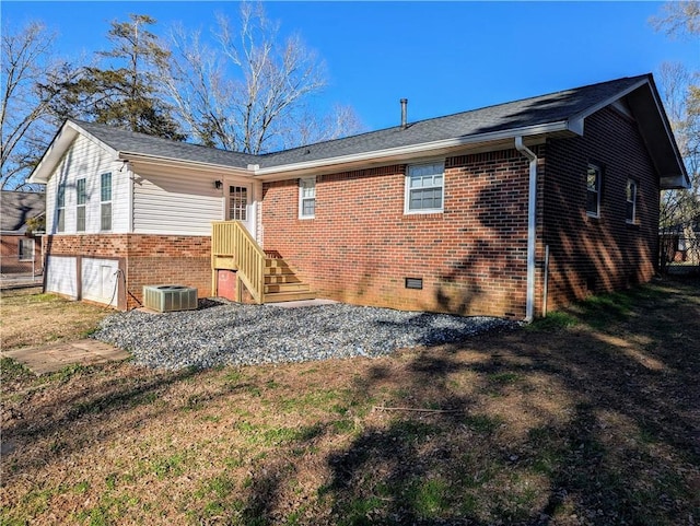 rear view of property featuring brick siding and cooling unit