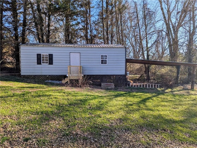 view of front facade with metal roof, a front lawn, and a carport