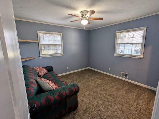 sitting room with crown molding, carpet flooring, visible vents, and baseboards