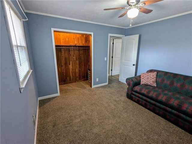 interior space featuring ceiling fan, ornamental molding, carpet flooring, and baseboards