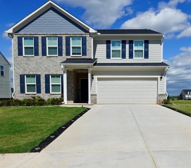 view of front of house featuring a garage and a front lawn