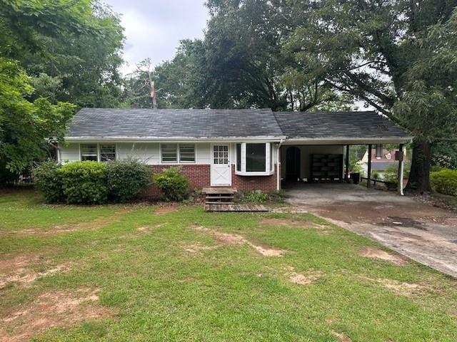 2588 Sandtown Rd SW, Marietta, GA 30060 - view of front of property with concrete driveway, an attached carport, a front lawn, and brick siding