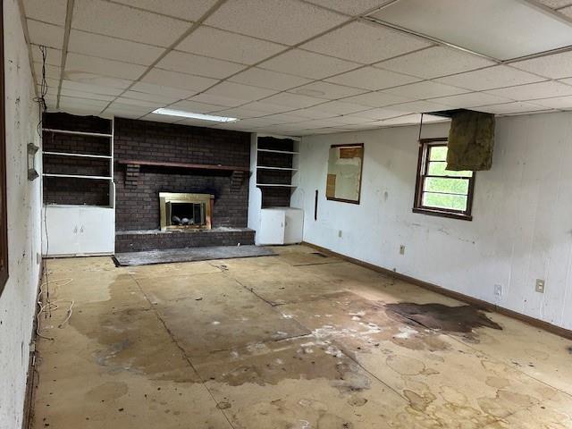 2588 Sandtown Rd SW, Marietta, GA 30060 - unfurnished living room featuring baseboards, a fireplace, and a drop ceiling