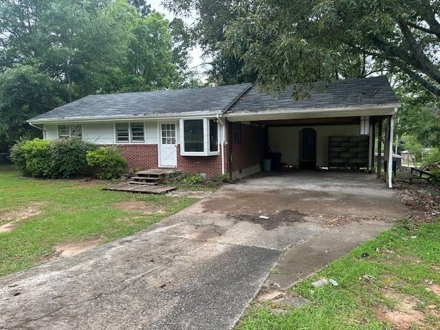 2588 Sandtown Rd SW, Marietta, GA 30060 - single story home featuring driveway, brick siding, a carport, and a front lawn
