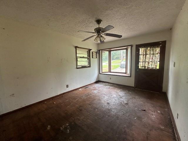 2588 Sandtown Rd SW, Marietta, GA 30060 - empty room with a textured ceiling, ceiling fan, and baseboards
