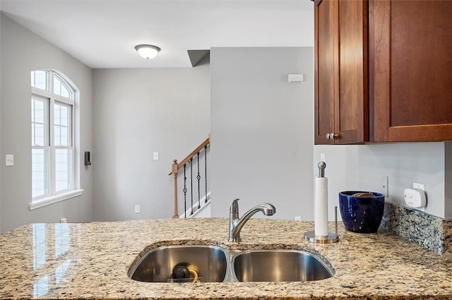 kitchen with light stone counters and sink