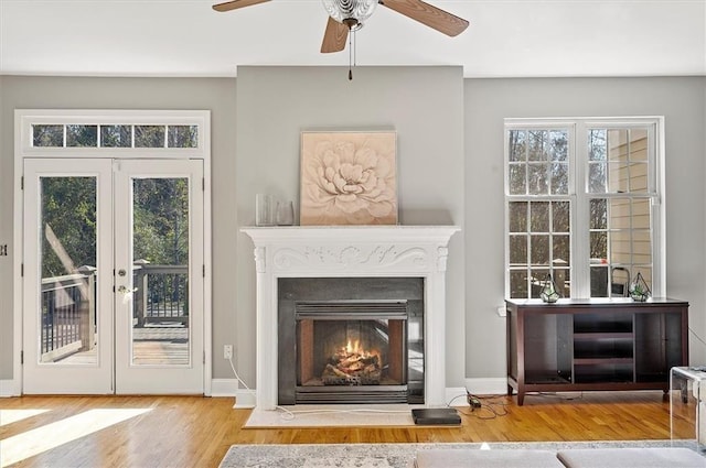 interior space featuring hardwood / wood-style floors, ceiling fan, and french doors