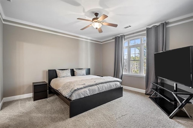 bedroom with ceiling fan, ornamental molding, and carpet floors