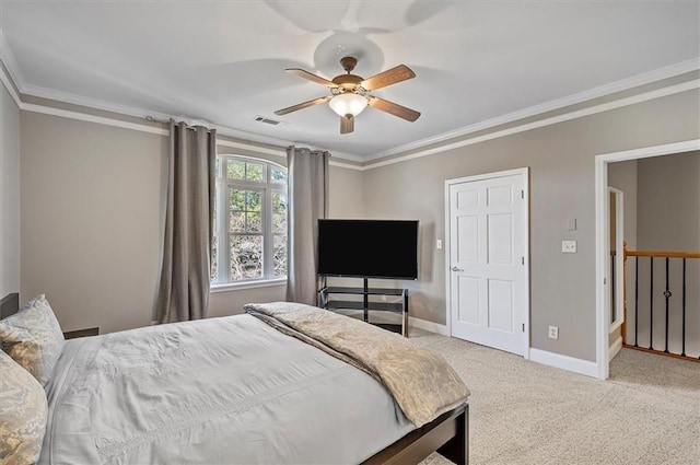 carpeted bedroom featuring ceiling fan and crown molding