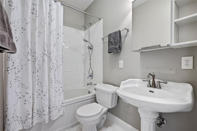 full bathroom featuring tile patterned floors, shower / bath combination with curtain, toilet, and sink