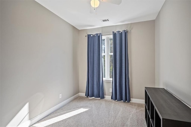 empty room featuring ceiling fan, a healthy amount of sunlight, and carpet floors