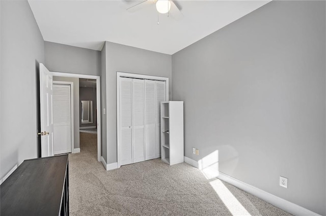 unfurnished bedroom with a closet, ceiling fan, and light colored carpet