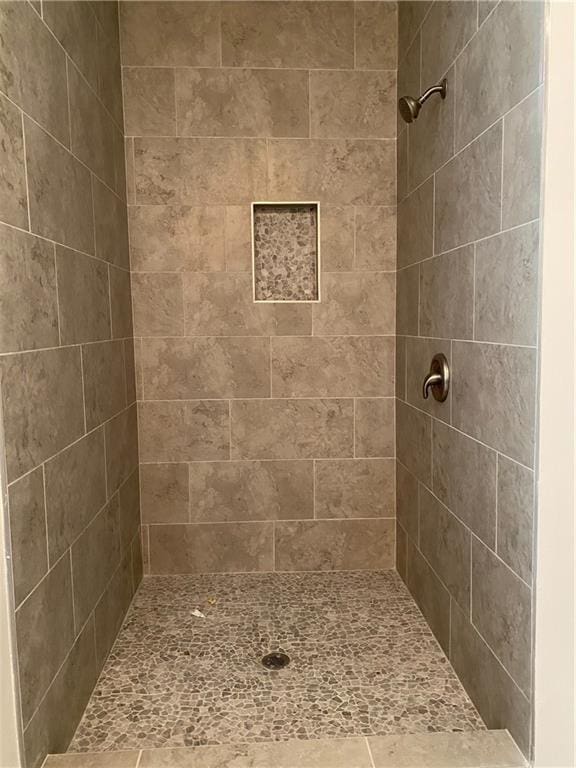 bathroom with tiled shower