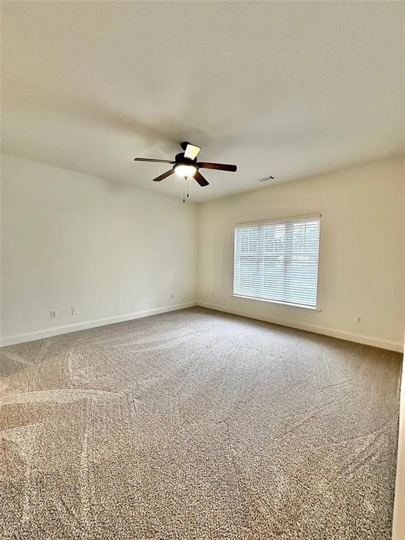 carpeted empty room with ceiling fan