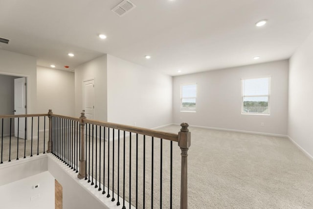 hall with carpet, recessed lighting, visible vents, an upstairs landing, and baseboards