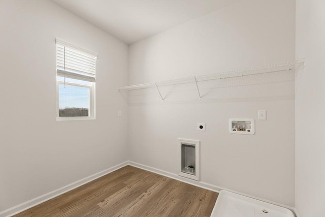 laundry room with hookup for a washing machine, electric dryer hookup, wood finished floors, laundry area, and baseboards