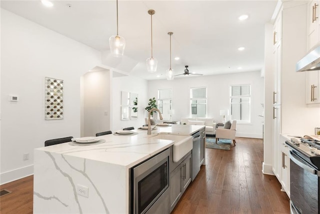 1032 Robert Smalls Way, Atlanta, GA 30318 - kitchen featuring appliances with stainless steel finishes, a sink, white cabinetry, a kitchen island with sink, and recessed lighting