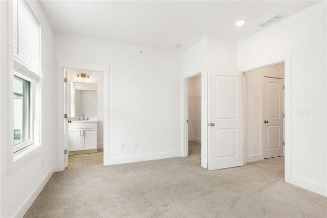 1032 Robert Smalls Way, Atlanta, GA 30318 - unfurnished bedroom with light carpet, a sink, a spacious closet, and multiple windows