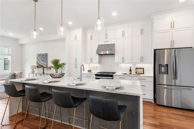 1032 Robert Smalls Way, Atlanta, GA 30318 - kitchen with stainless steel appliances, under cabinet range hood, white cabinetry, a sink, and recessed lighting
