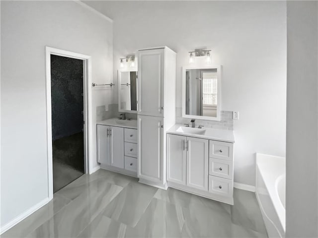 full bathroom with two vanities, a sink, and a bath