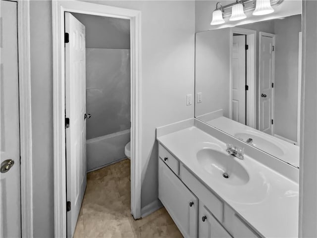 bathroom featuring toilet, washtub / shower combination, and vanity