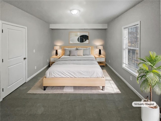 carpeted bedroom featuring baseboards