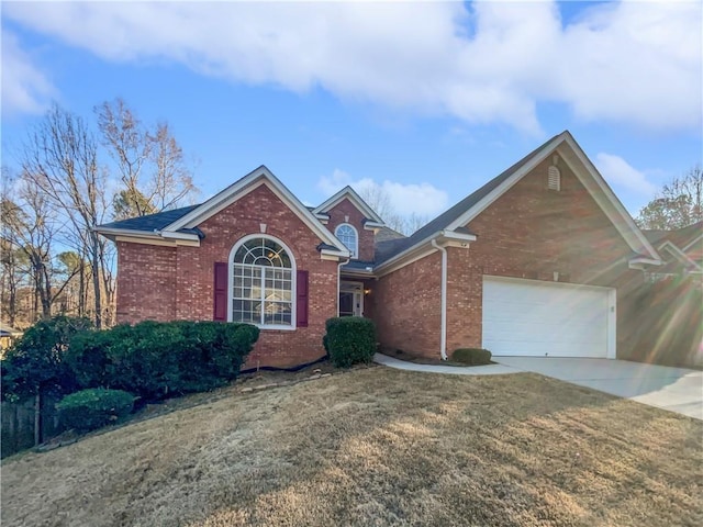 view of front of house featuring a garage, driveway, brick siding, and a front lawn