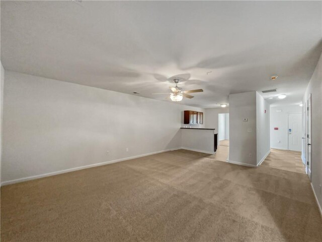 empty room with ceiling fan and light colored carpet