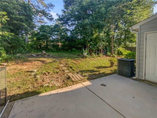 view of yard featuring a patio and central AC