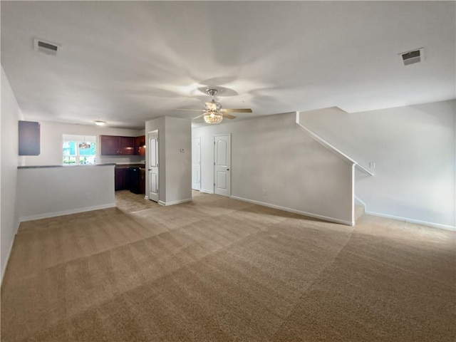 unfurnished living room featuring light colored carpet and ceiling fan