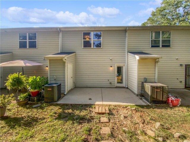 rear view of house with a patio and central air condition unit