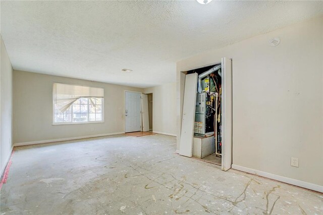 unfurnished room with a textured ceiling