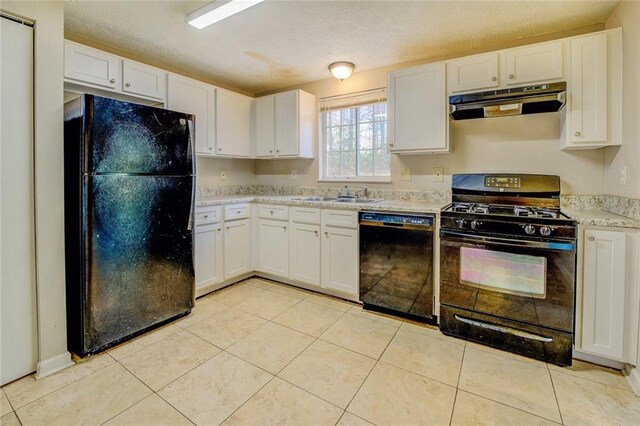 kitchen featuring light stone countertops, sink, a textured ceiling, white cabinets, and black appliances