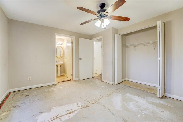 unfurnished bedroom featuring ceiling fan, sink, ensuite bathroom, and a closet