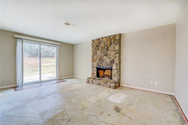 unfurnished living room featuring a fireplace and a textured ceiling