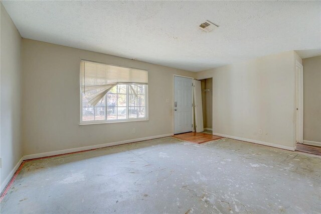 spare room with a textured ceiling