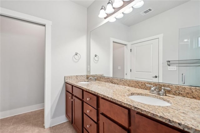 full bath with tile patterned flooring, double vanity, visible vents, and a sink