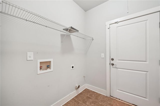 washroom featuring baseboards, laundry area, dark tile patterned flooring, electric dryer hookup, and washer hookup