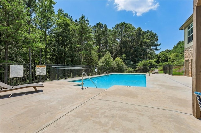 community pool featuring a patio and fence