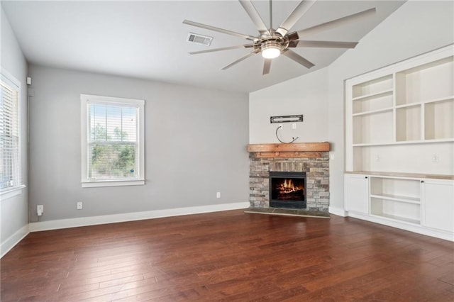 unfurnished living room with visible vents, a fireplace, baseboards, and dark wood-style flooring