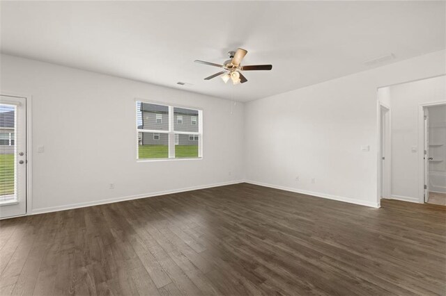 unfurnished living room with dark wood-type flooring and ceiling fan